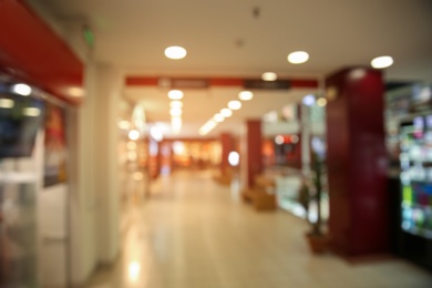 Photo of Blurred view of modern shopping mall interior