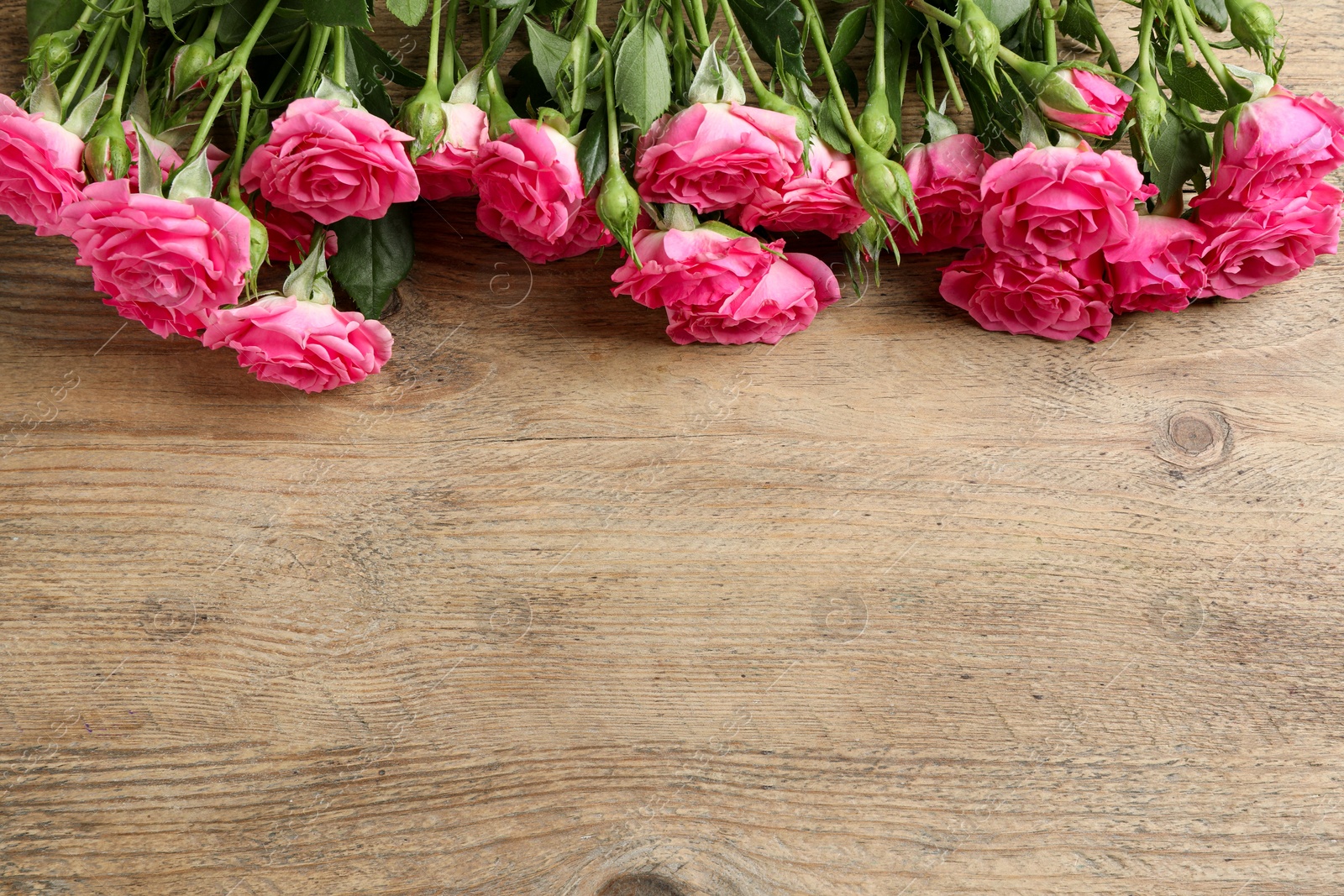 Photo of Happy Mother's Day. Beautiful flowers on wooden table, above view. Space for text