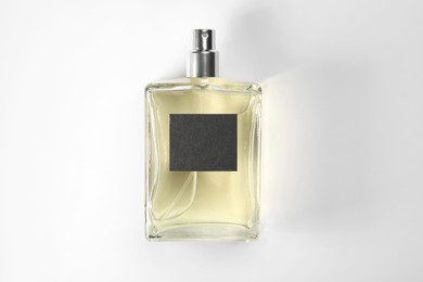 Photo of Luxury men's perfume in bottle on white background, top view