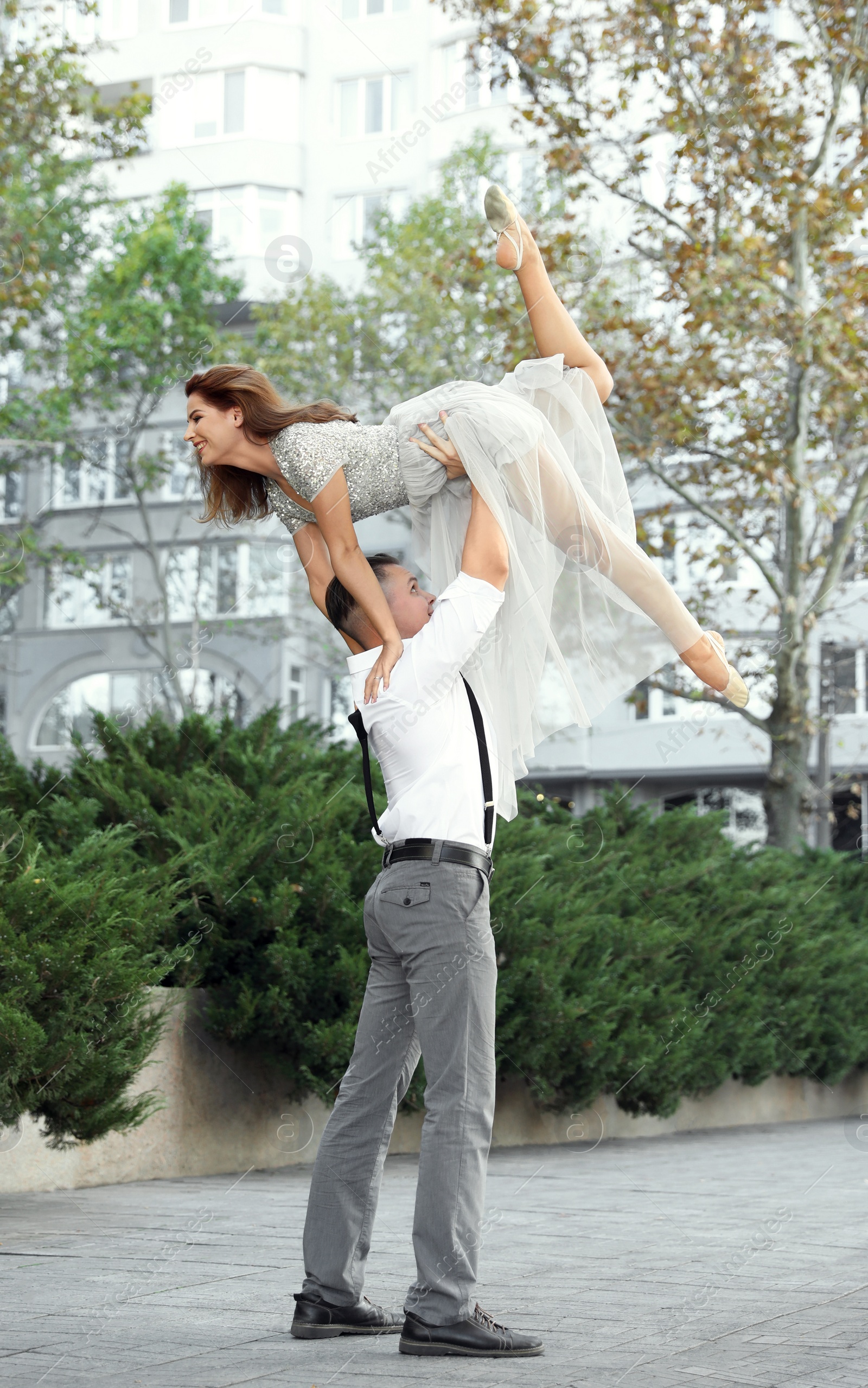 Photo of Beautiful young couple practicing dance moves outdoors