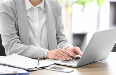 Consultant working at table in office, closeup