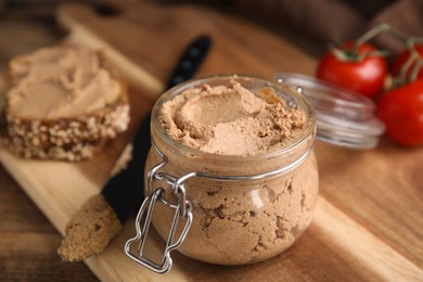 Photo of Delicious meat pate with knife on wooden table, closeup