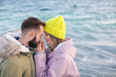 Photo of Lovely young couple near sea. Space for text