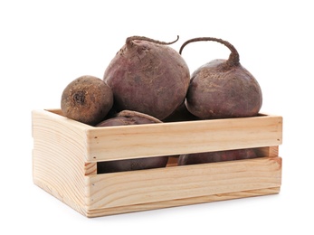 Photo of Wooden crate with organic beets on white background. Taproot vegetable