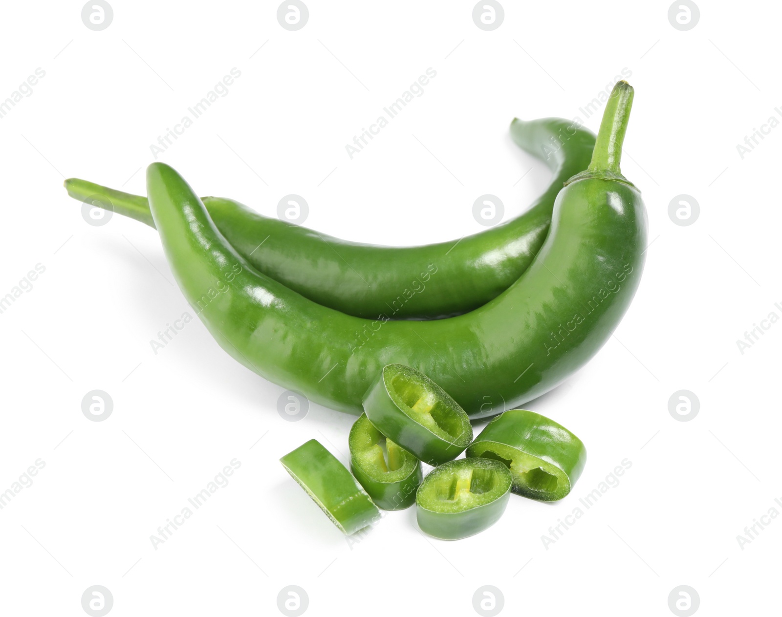 Photo of Cut and whole green hot chili peppers on white background