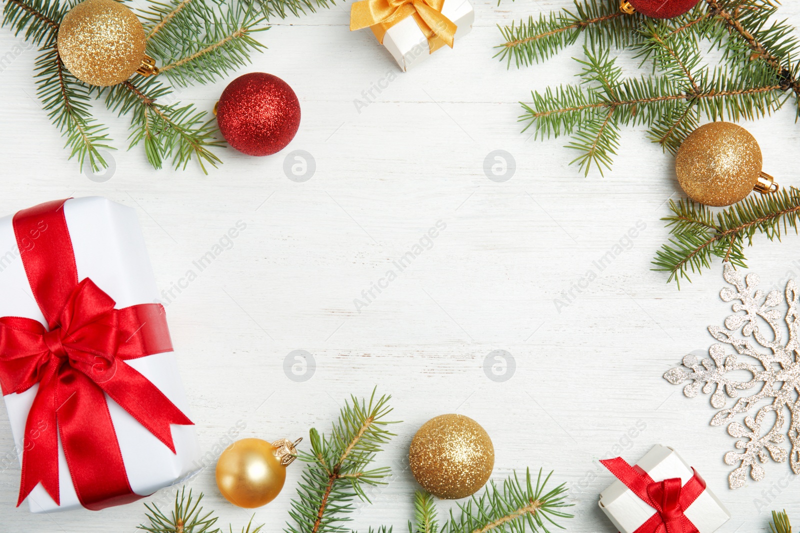 Photo of Flat lay composition with Christmas tree branches and festive decor on wooden background