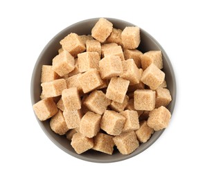 Photo of Bowl and brown sugar cubes on white background, top view