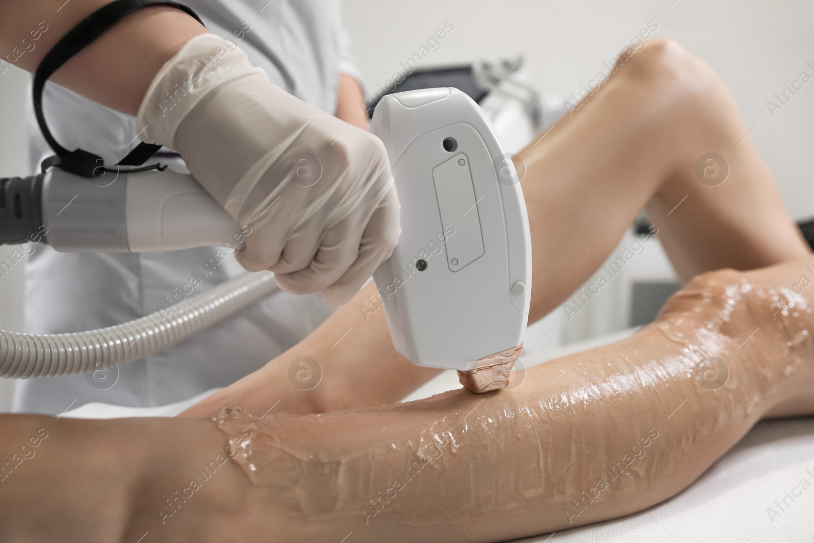 Photo of Woman undergoing laser epilation procedure in beauty salon, closeup