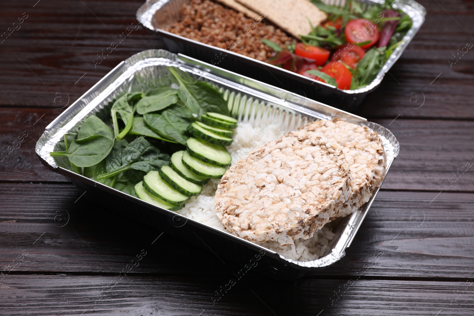 Photo of Containers with different fresh products on wooden table