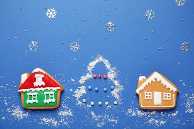 Flat lay composition with tasty homemade Christmas cookies on blue background