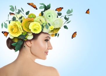 Image of Pretty woman wearing beautiful wreath made of flowers on light blue background