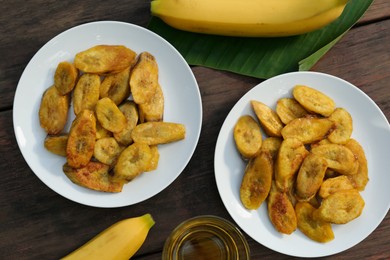 Flat lay composition with deep fried banana slices on wooden table