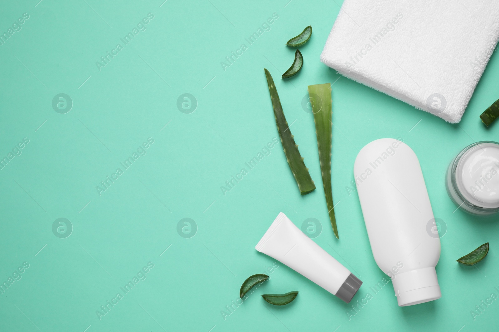 Photo of Flat lay composition with aloe vera and cosmetic products on turquoise background. Space for text