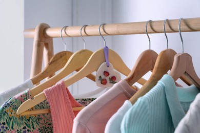 Beautiful scented wax sachet and clothes hanging on wooden rack indoors