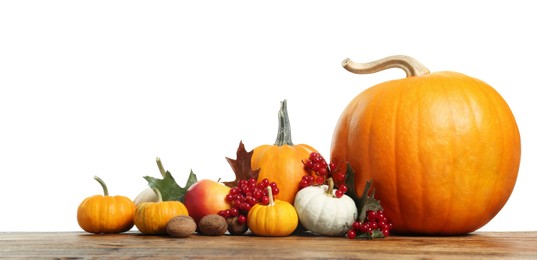 Photo of Happy Thanksgiving day. Composition with pumpkins, berries and walnuts on wooden table against white background. Space for text