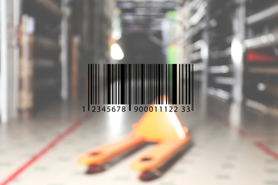 Image of Barcode and blurred view of modern wholesale warehouse with manual pallet truck 