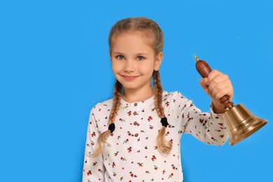 Pupil with school bell on light blue background