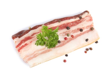 Piece of bacon with peppercorn and parsley isolated on white, top view