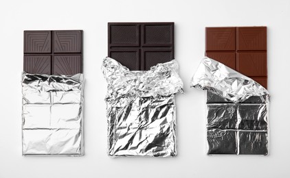 Photo of Tasty chocolate bars on white background, top view