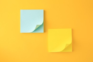Photo of Blank paper notes on orange background, flat lay
