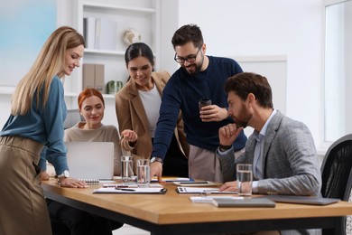 Team of employees working together in office