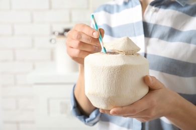 Photo of Woman with fresh coconut drink in nut, closeup