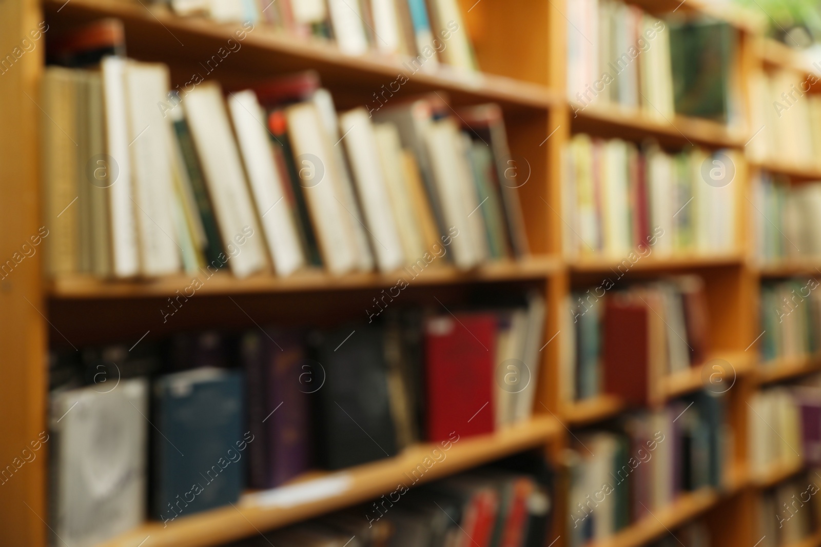 Photo of Blurred view of cabinets with books in library