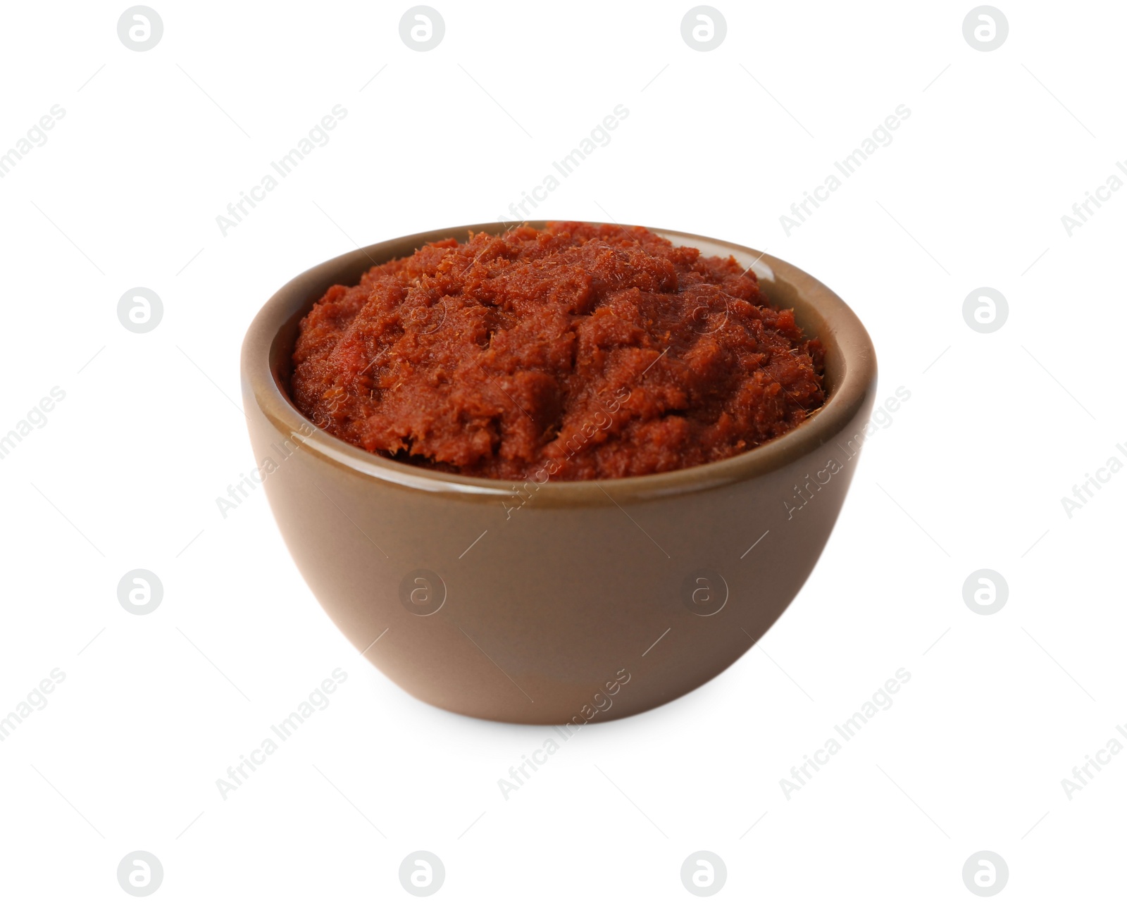 Photo of Tasty curry paste in bowl isolated on white