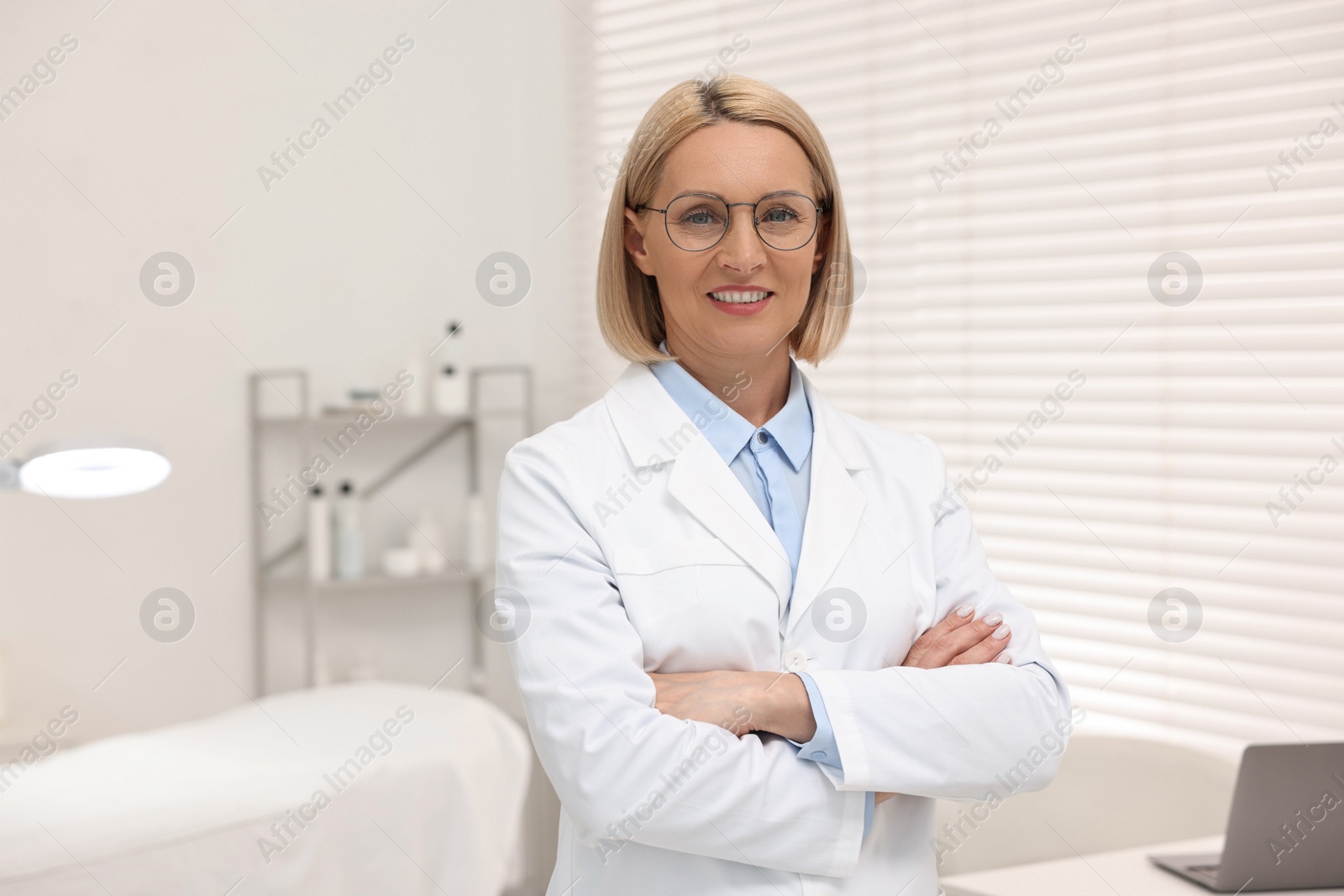 Photo of Portrait of happy dermatologist in modern clinic