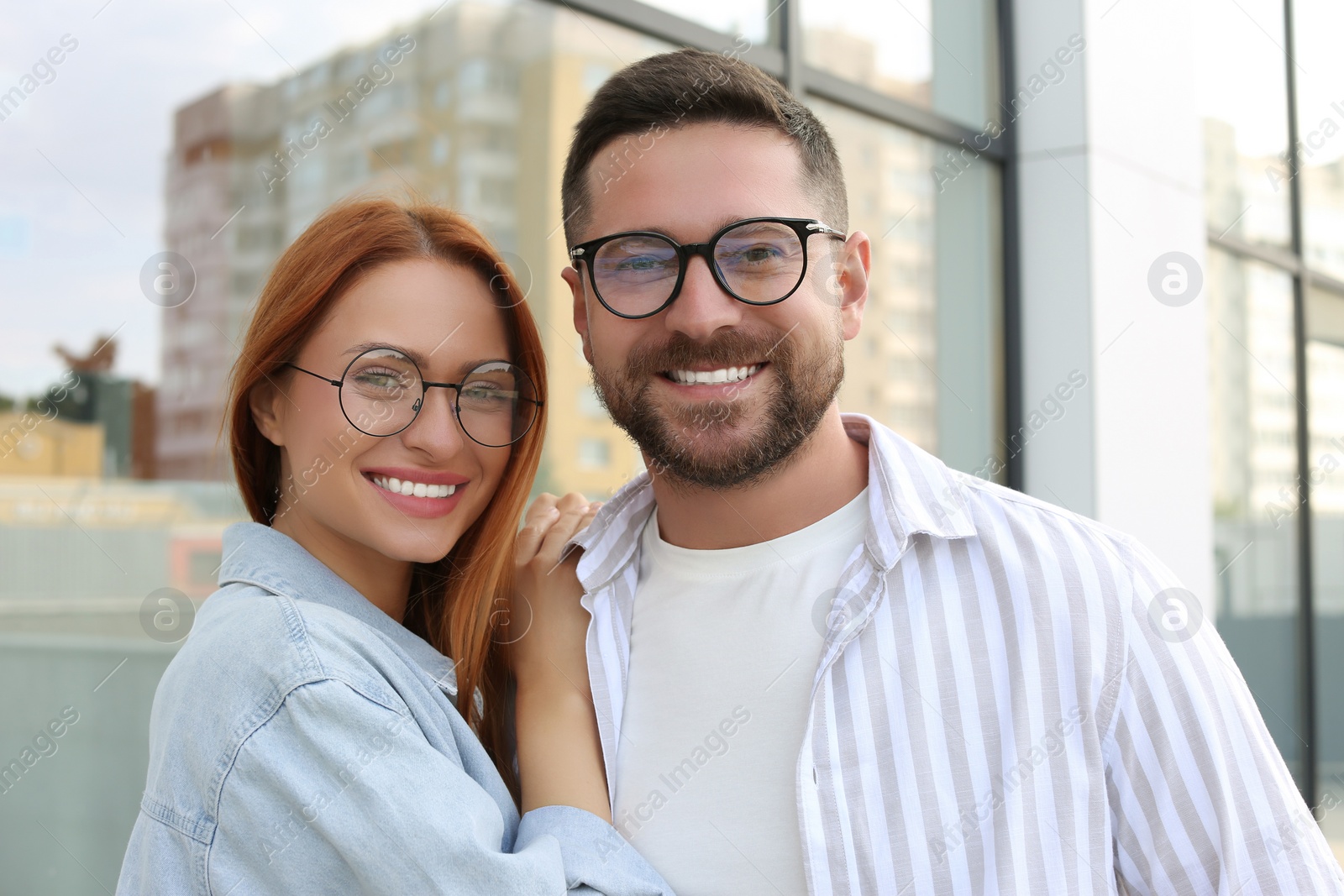 Photo of Portrait of happy couple in glasses outdoors