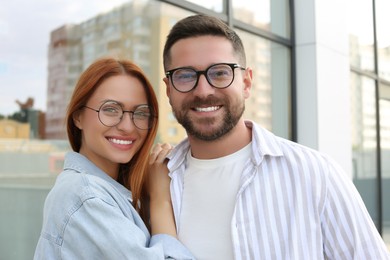 Photo of Portrait of happy couple in glasses outdoors