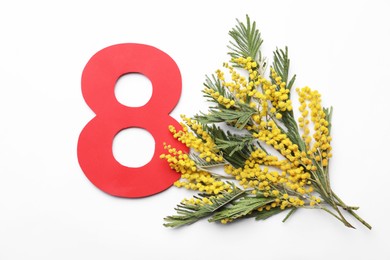 Photo of 8 March greeting card design with beautiful mimosa flowers on white background, flat lay