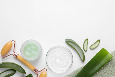 Flat lay composition with cosmetic products and cut aloe leaves on white background. Space for text