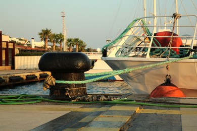 Photo of Mooring pole with rope in sea port