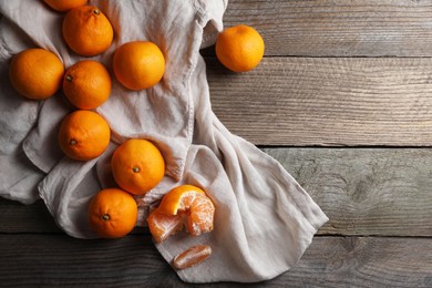 Tasty fresh tangerines on wooden table, flat lay. Space for text