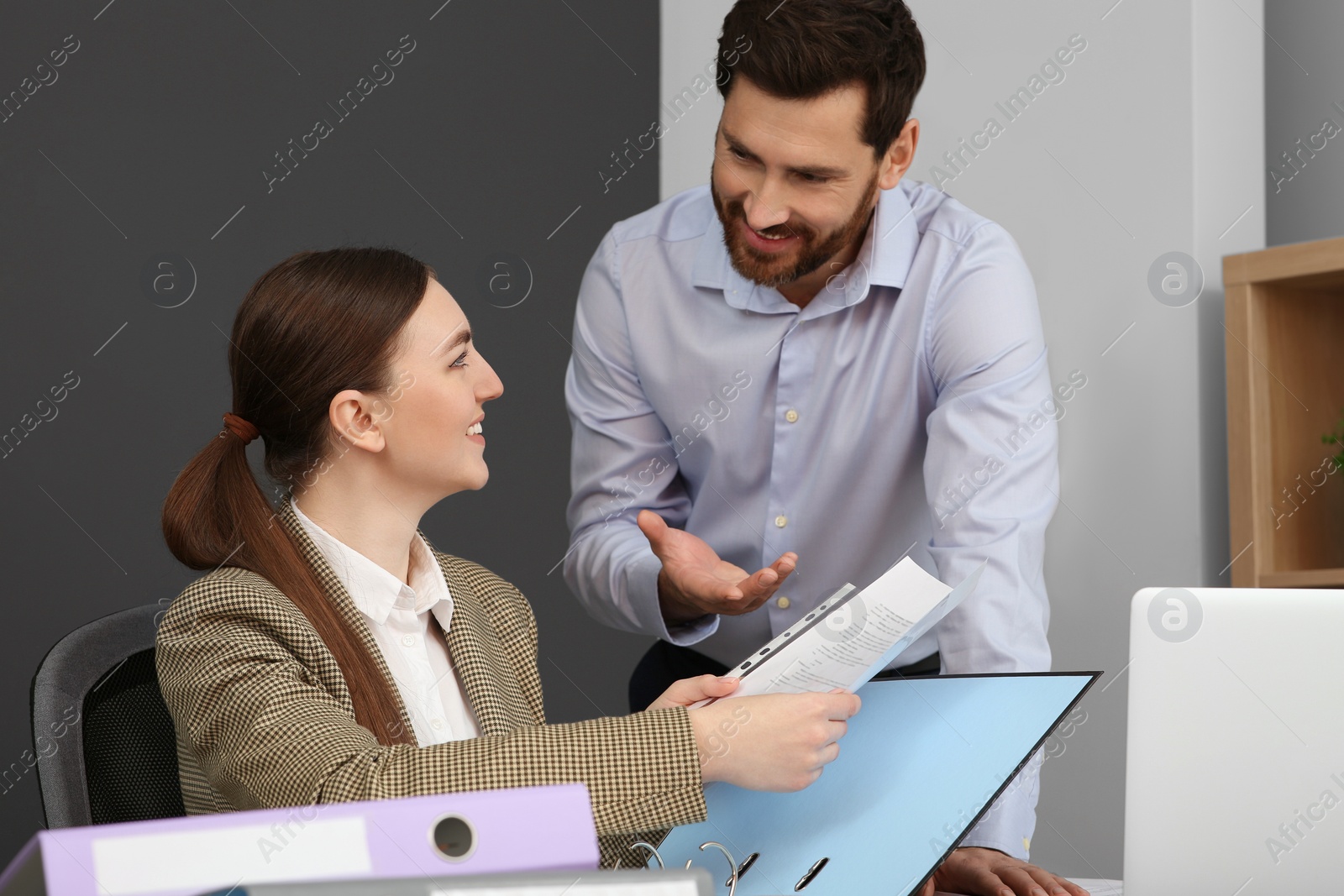 Photo of Businesspeople working together with documents in office