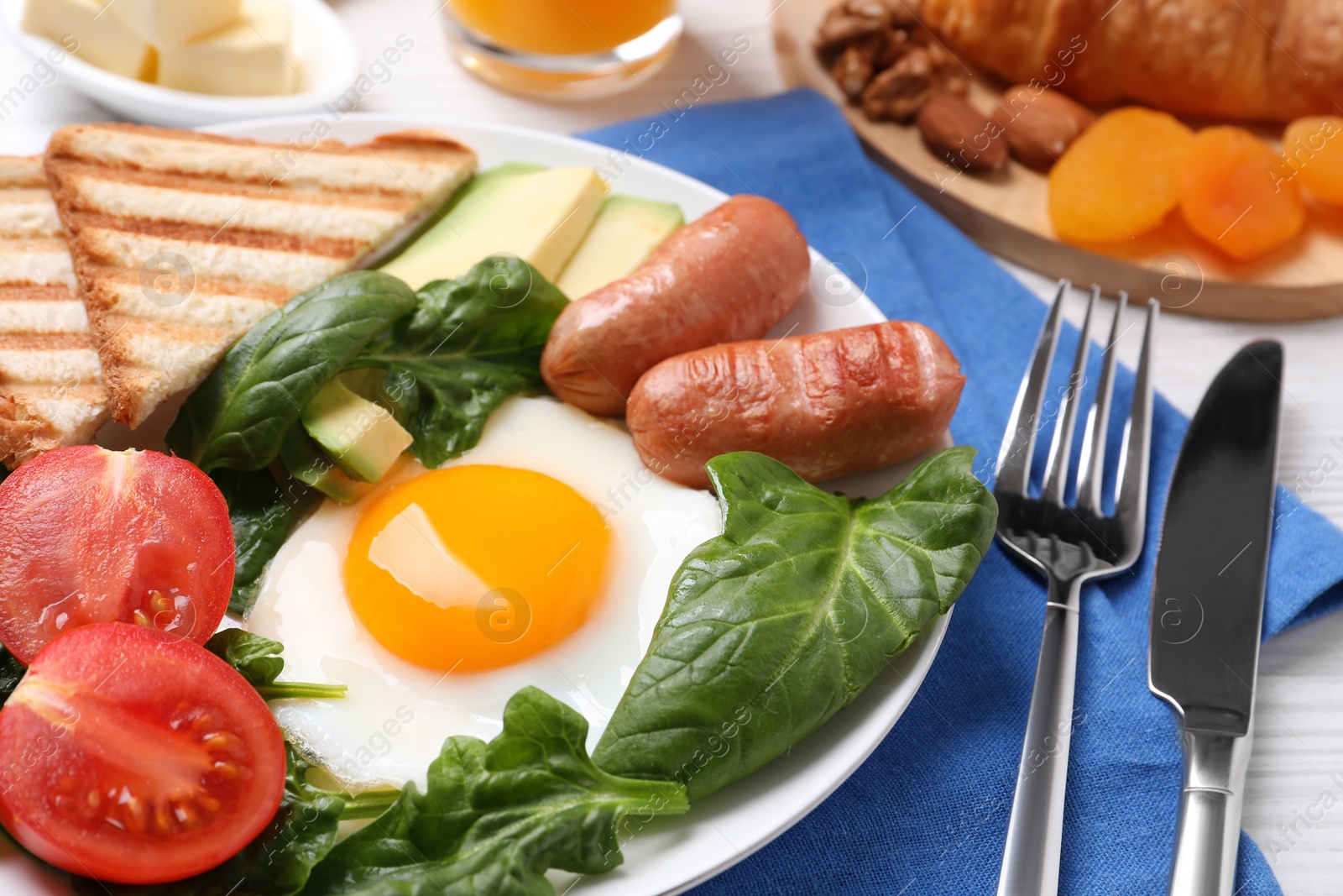 Photo of Delicious breakfast with fried egg served on table, closeup