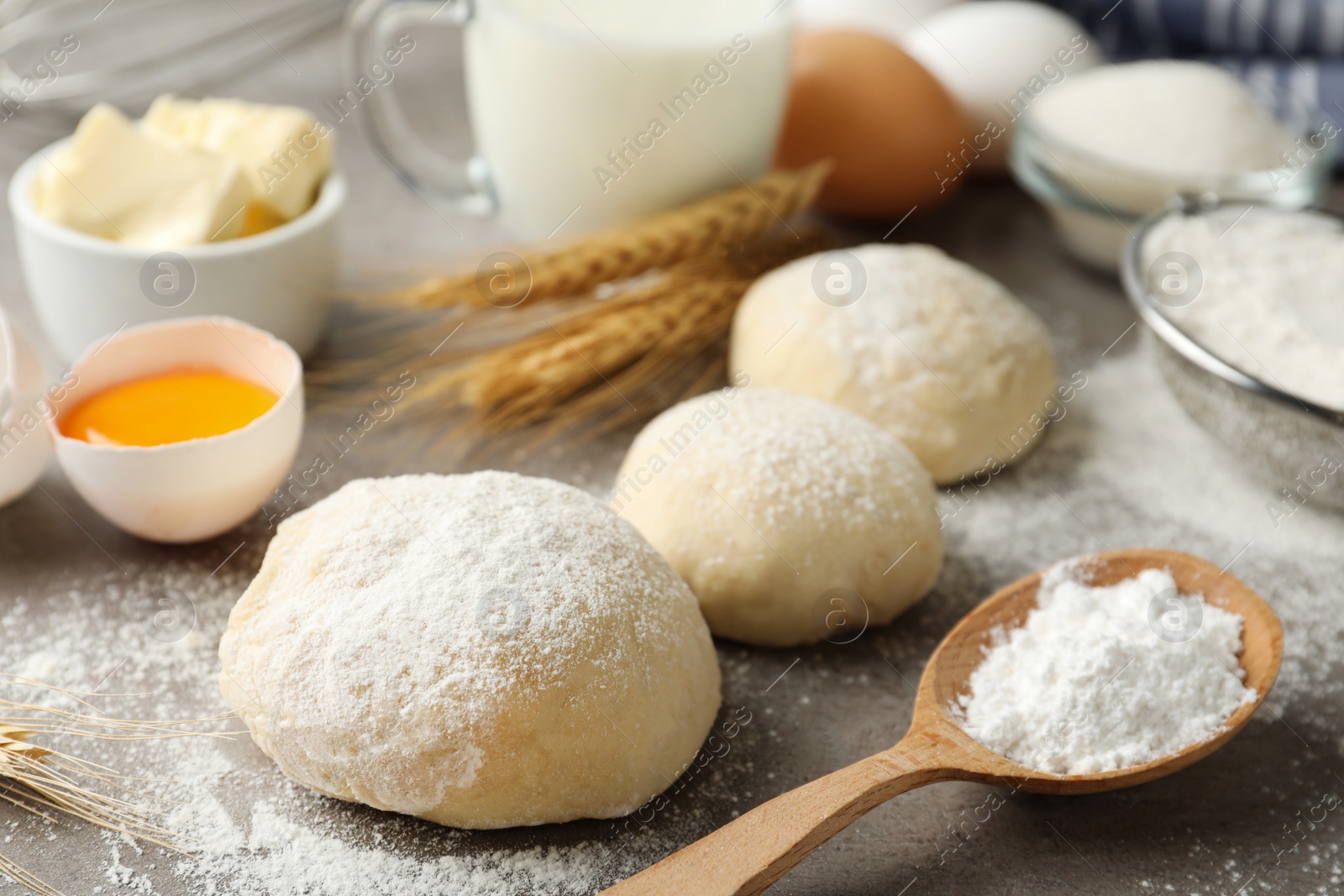 Photo of Dough and other ingredients for pastries on light grey table