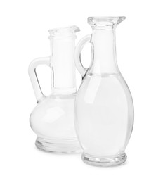 Vinegar in glass jugs isolated on white