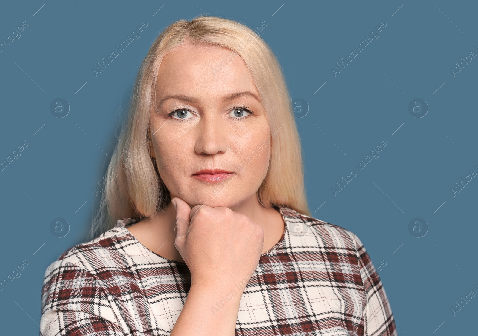 Photo of Portrait of beautiful mature woman on color background