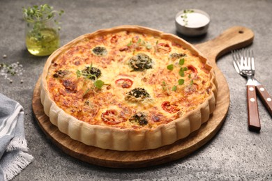 Photo of Delicious homemade vegetable quiche on gray table