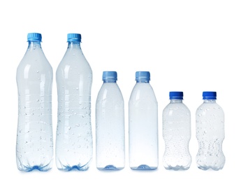 Photo of Empty plastic bottles on white background. Recycling problem