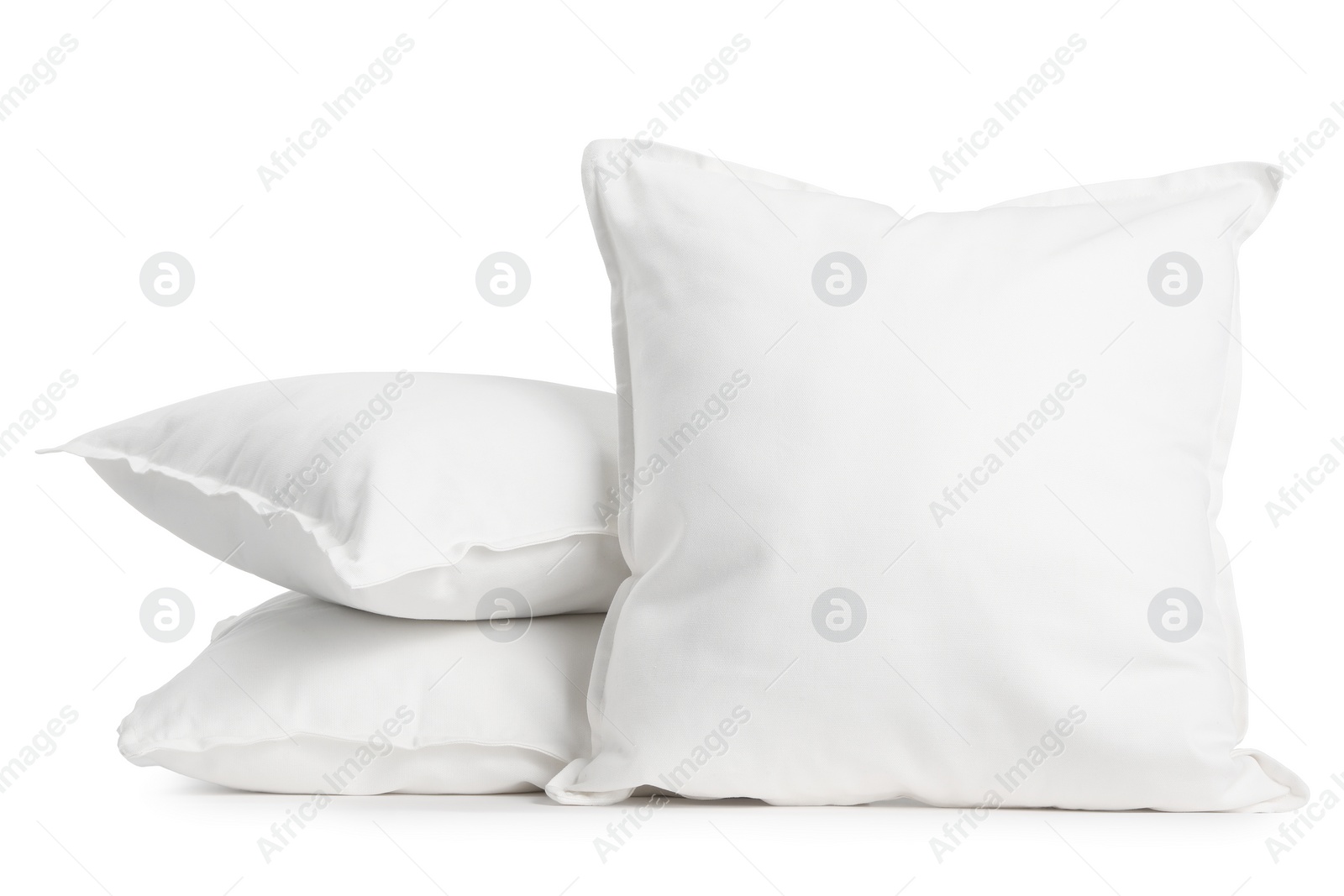 Photo of Three new soft pillows isolated on white