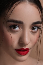 Portrait of beautiful young woman with red lips, closeup