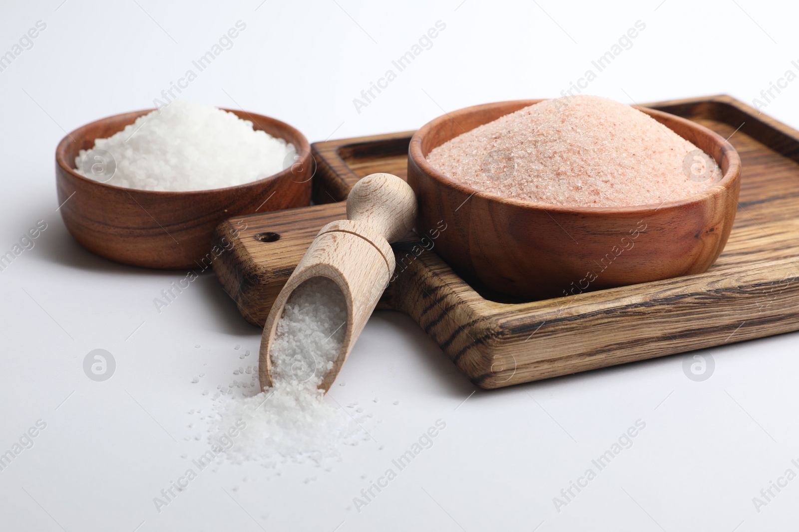 Photo of Different types of natural salt on white background