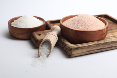 Photo of Different types of natural salt on white background