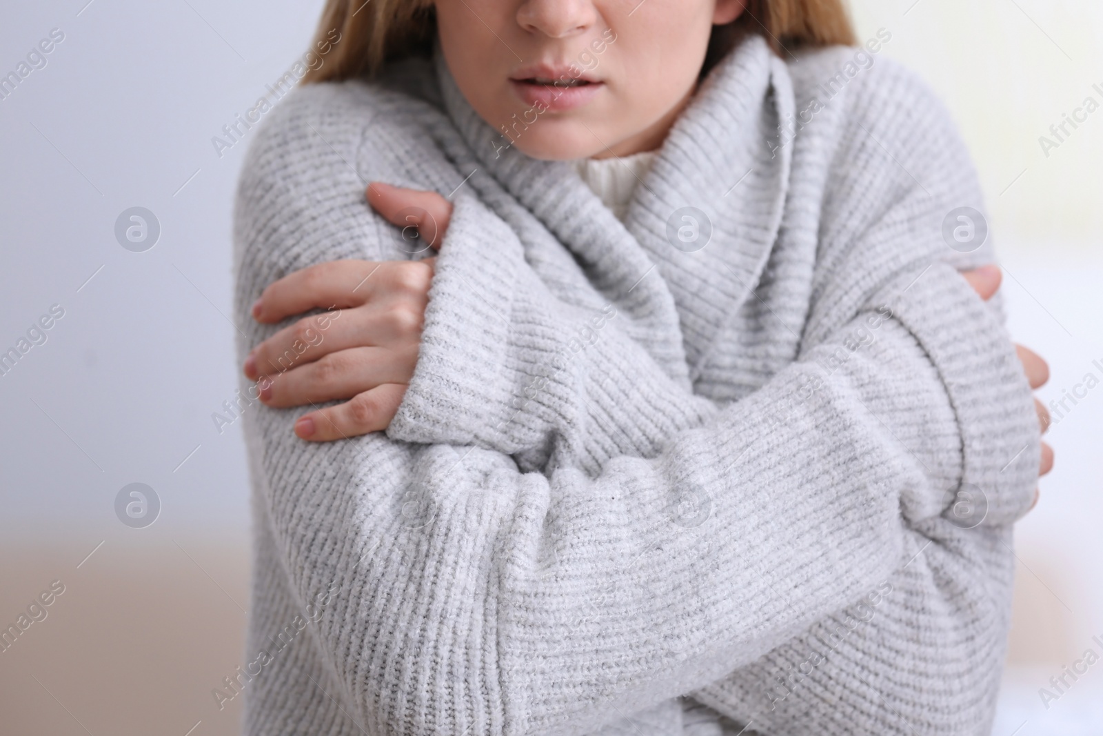 Photo of Woman suffering from cold on blurred background