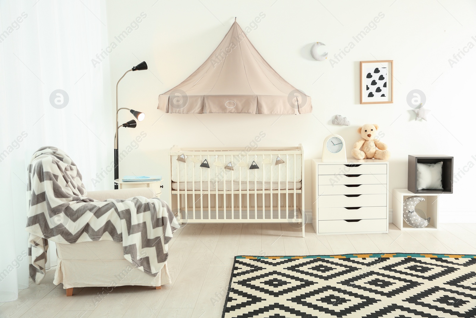 Photo of Stylish baby room interior with crib