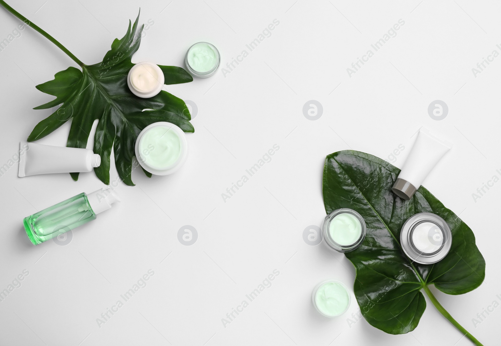 Photo of Flat lay composition with cosmetic products on light background