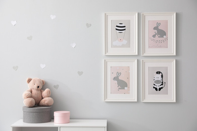 Photo of Stylish baby room interior with cute pictures on wall